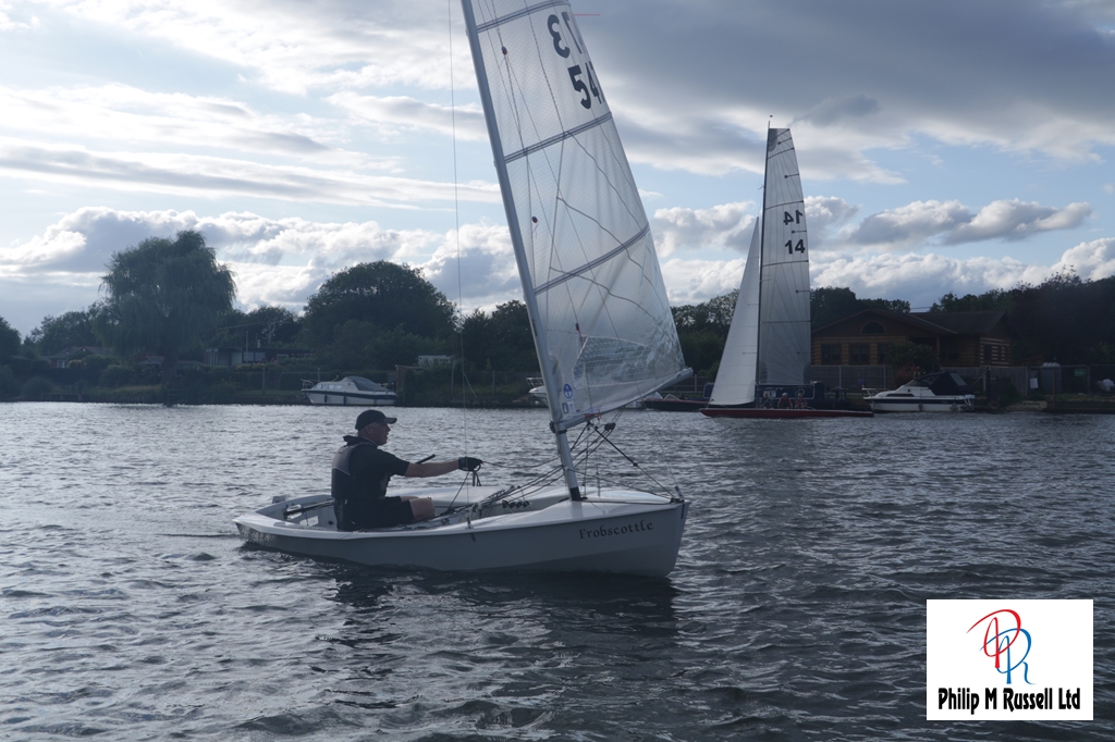 A sailing dinghy passes the camera boat