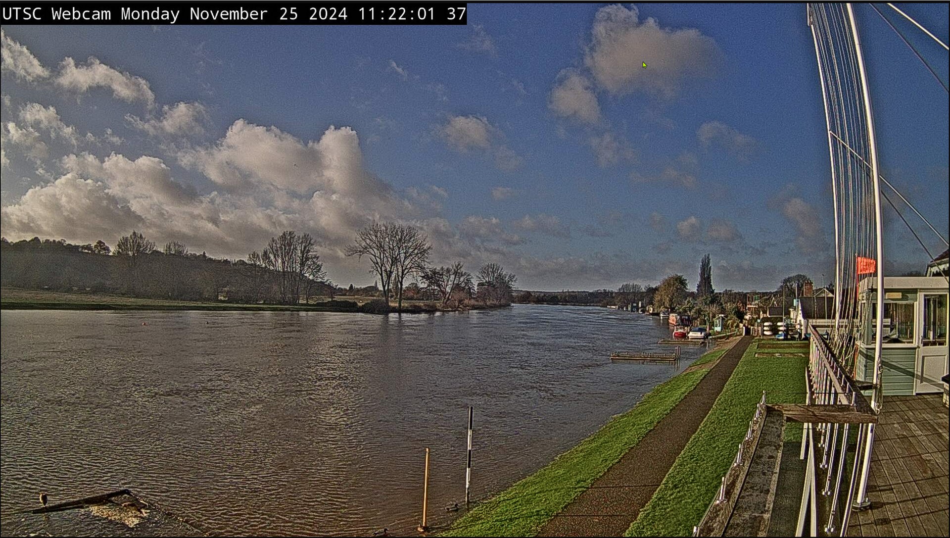 Monday morning sees the Thames over the Hrd and starting to eat into the grassy verge. Fluffy white clouds are in the sky.