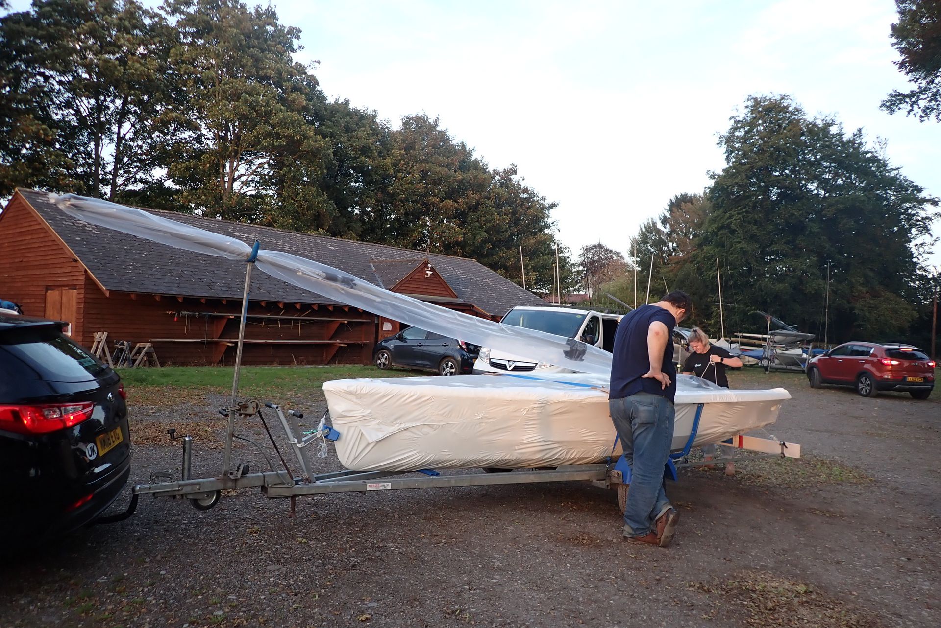 Read the full story of buying, fitting out and sailing our boats. In the picture Paul is standing next to a shrink wrapped boat.
