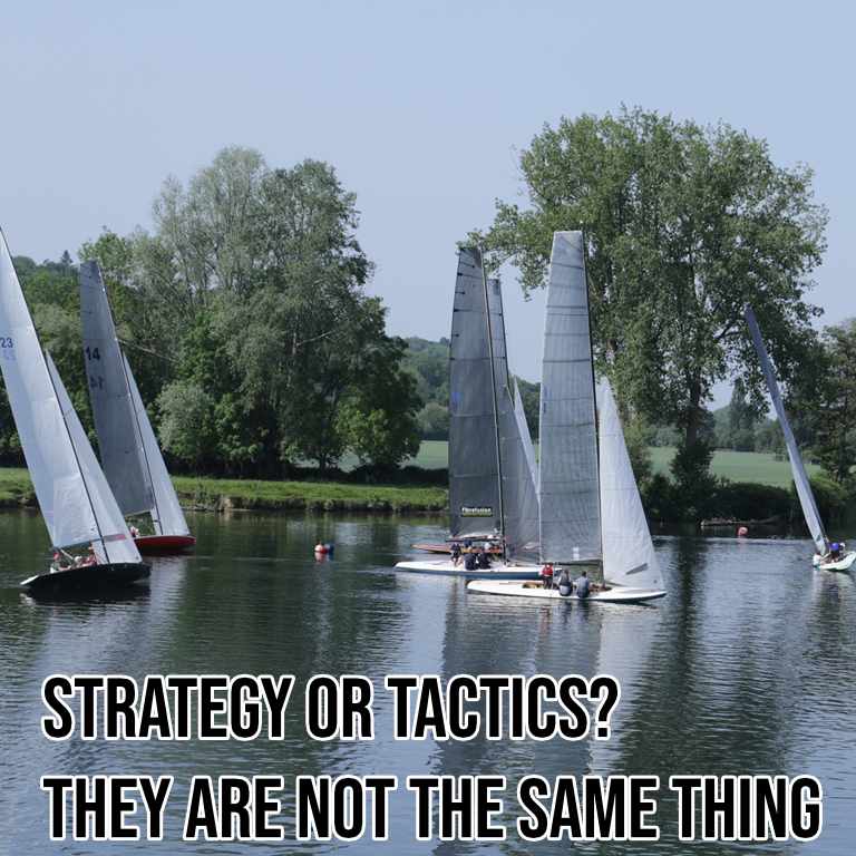 Two three-person Thames A-Rater sailing dinghies approach one another on a tree-lined river during a race, illustrating how other competitors can affect a planned route.