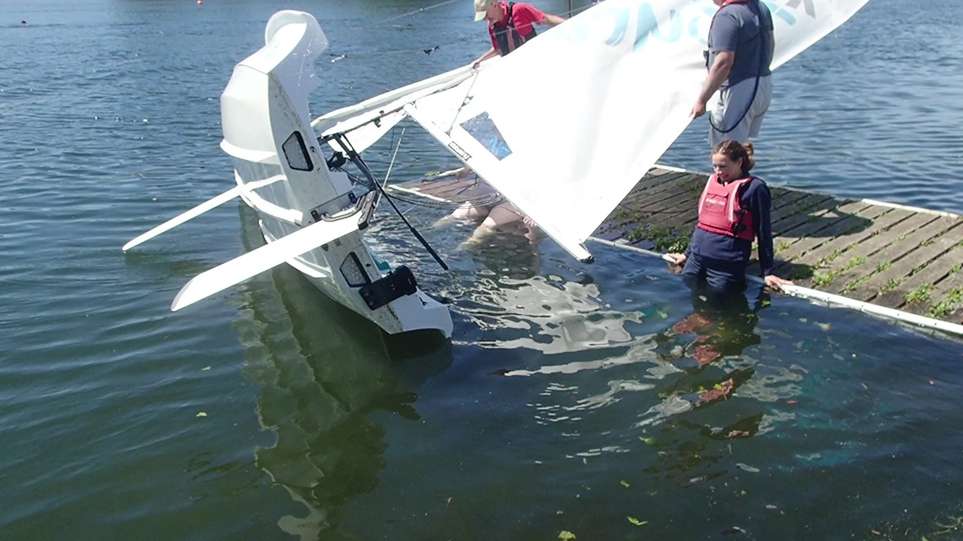 First Capsize practice. Learning to right the boat from the safety of a pontoon