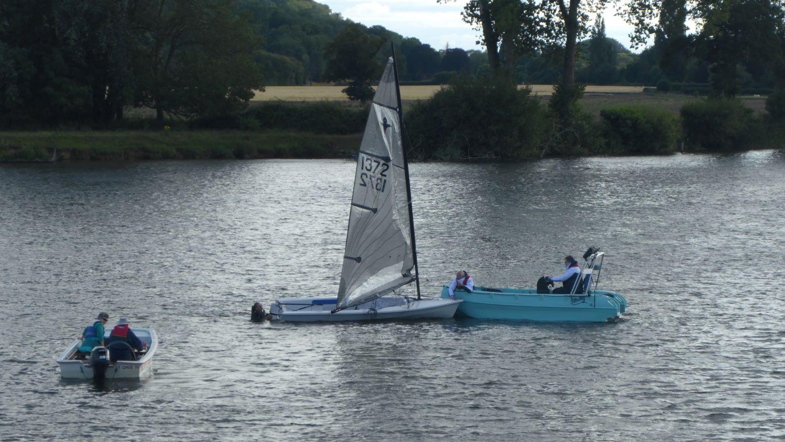 The camera boat arrived at the capsized dinghy first and became the safety boat. the Other safety boat stood by if we required assistance