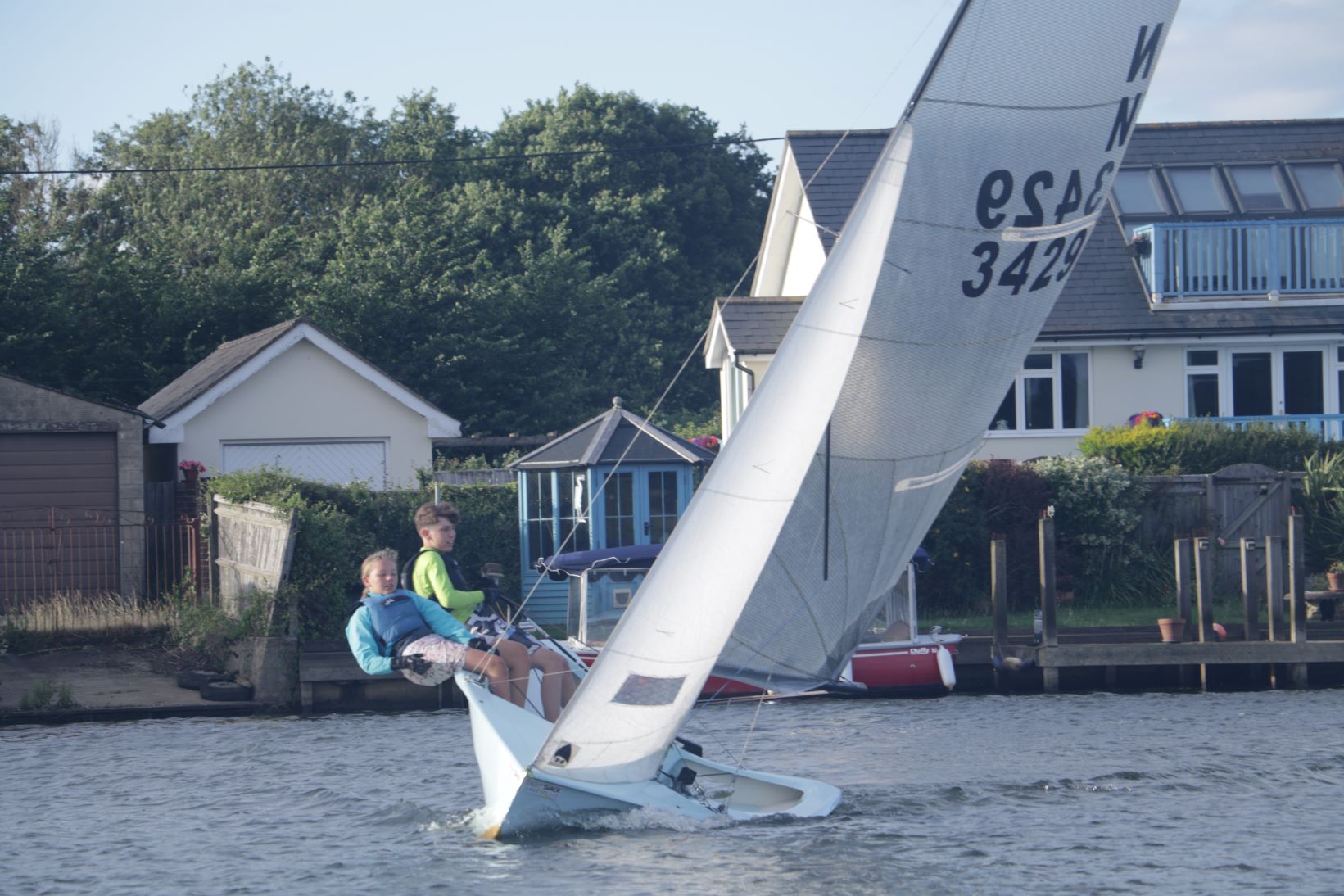 A national 12 with its young crew hanging out and balancing the boat